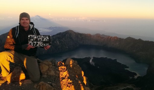 Sunrise at the summit. The caldera, volcanic lake and full moon are in the distance